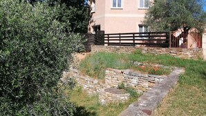 A two-story building with a stone pathway leading to the entrance.
