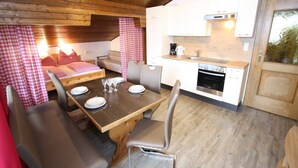 A compact kitchen with white cabinets and a stainless steel oven.