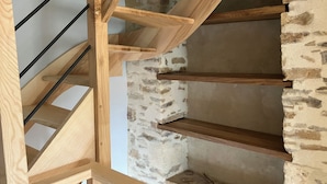 A wooden staircase with a stone wall background. - to get together with family or friends and discover Normandy (Feuguerolles-Bully)