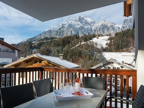 Enjoy a romantic meal on the balcony with breathtaking views of snow-capped mountains and a forested valley.