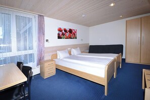 Hypo-allergenic bedding, down duvets, desk, laptop workspace