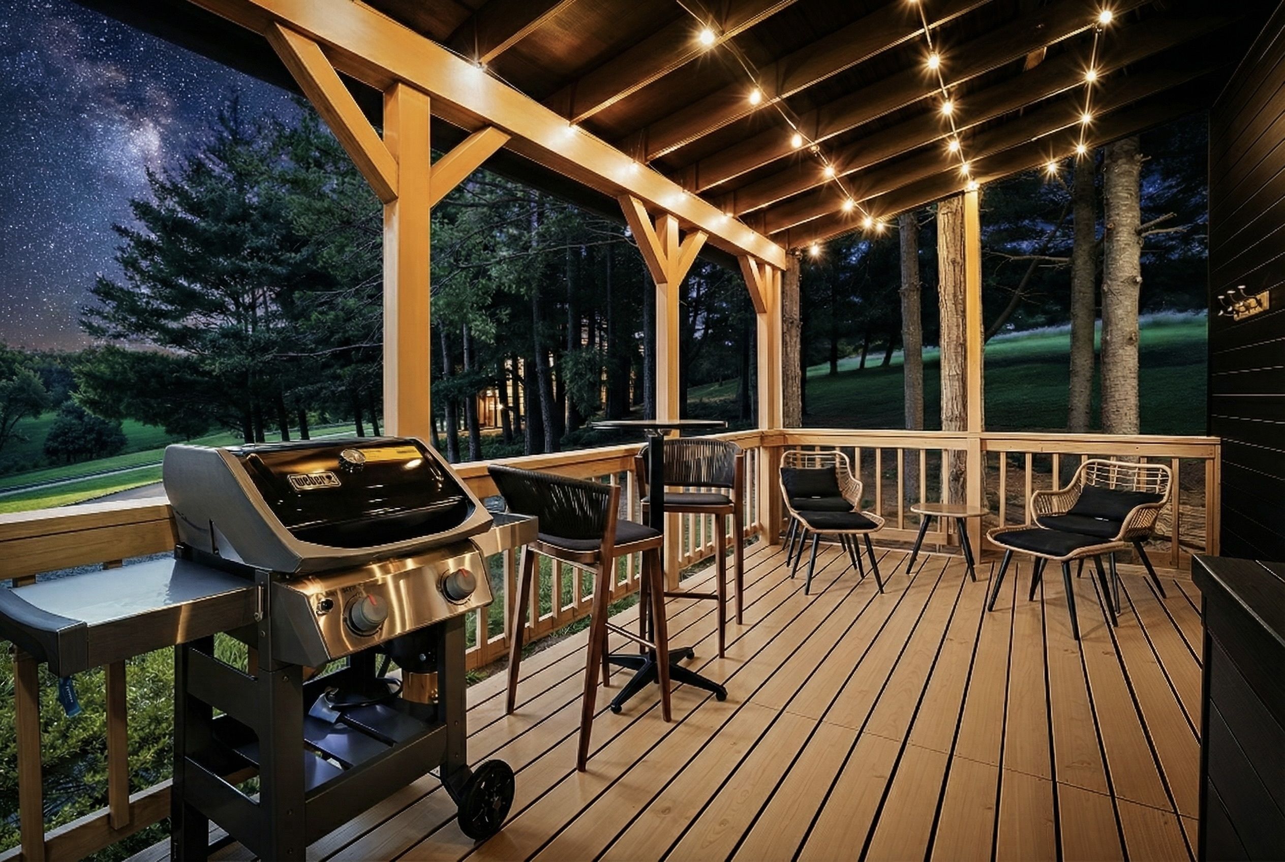 A deck with a grill, chairs, and a view of the night sky.