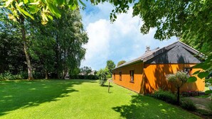 A house with a well-maintained lawn and a small garden area.