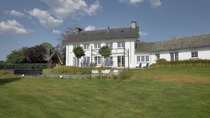 A large white house with a spacious lawn, a pool, and outdoor seating. - Scenic Theux Retreat with Pool & Garden. (Theux)