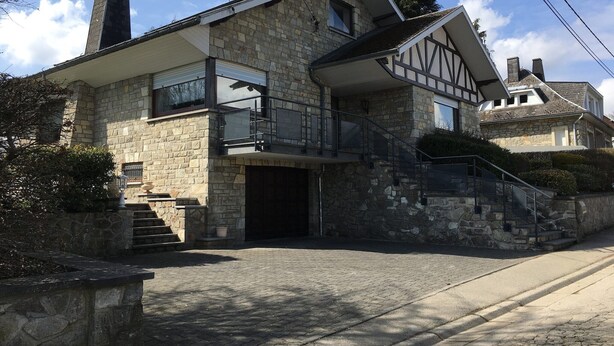 A stone house with a balcony, a staircase leading to the entrance, and a clear sky. - Waimes Retreat Near Forest (Waimes)