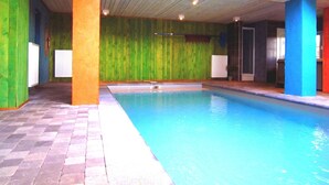 An indoor swimming pool with a wooden ceiling and walls painted in green, blue, and orange. - Wellness & Wilderness: Libômont Escape (Waimes)