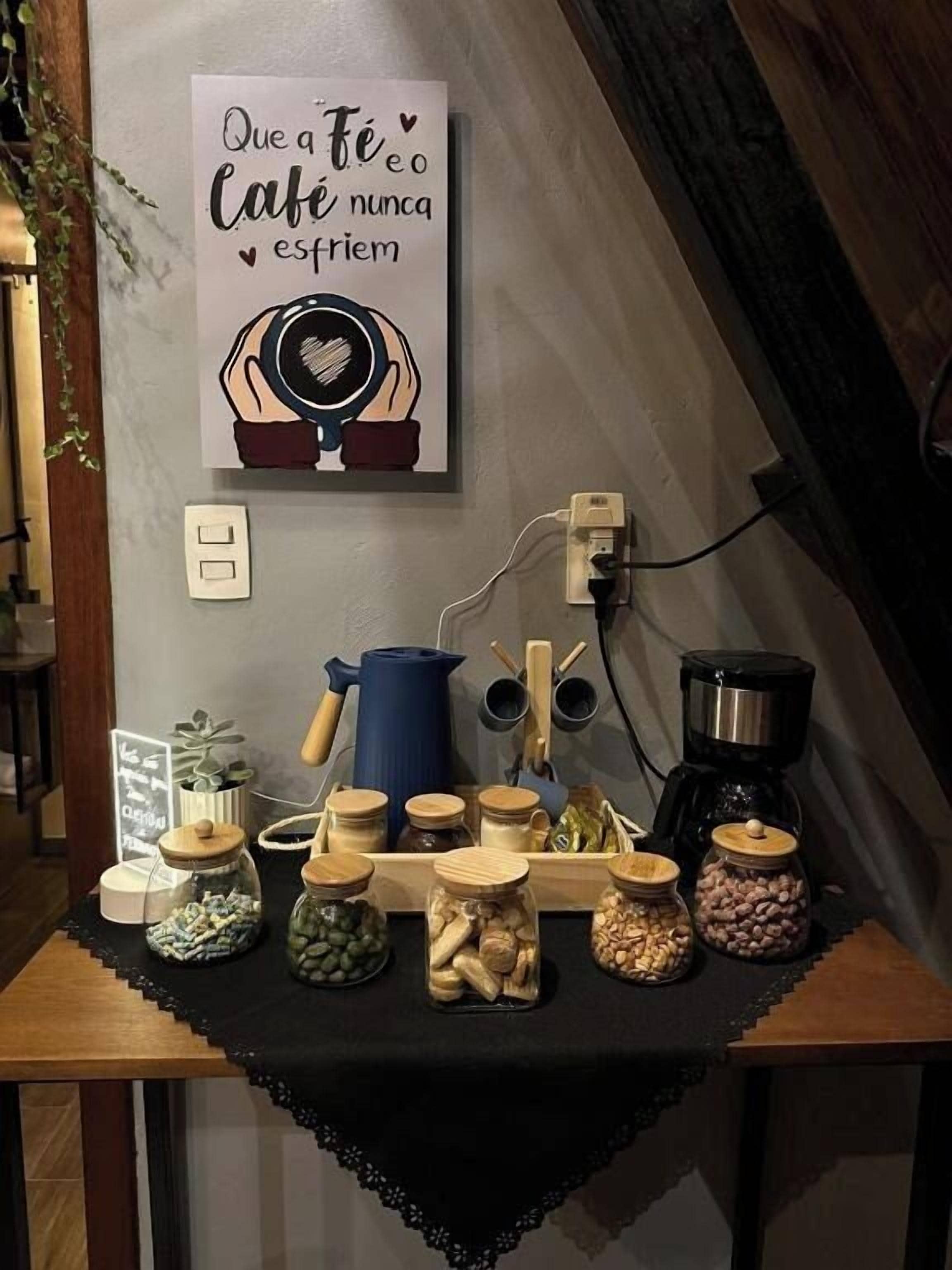 Un plan de travail de cuisine avec divers pots contenant des ingrédients, une machine à café et une bouilloire.