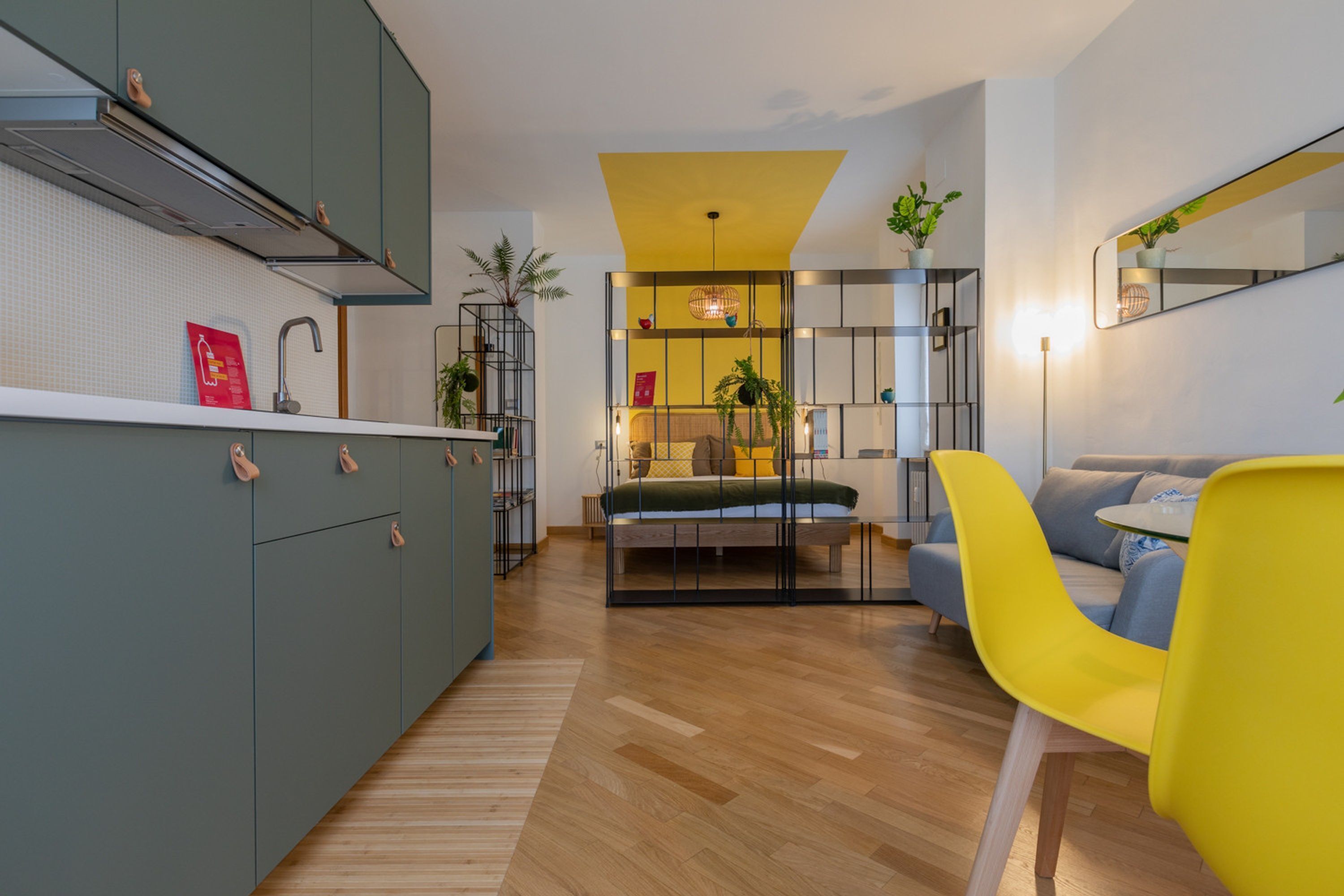 A modern apartment with a kitchen, a dining area, and a living room.