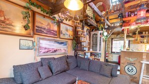 A cozy living room with a large sectional sofa, wooden coffee table, and various decorative items. - Ferienhaus in Wismar mit eigener Terrasse (Wismar)