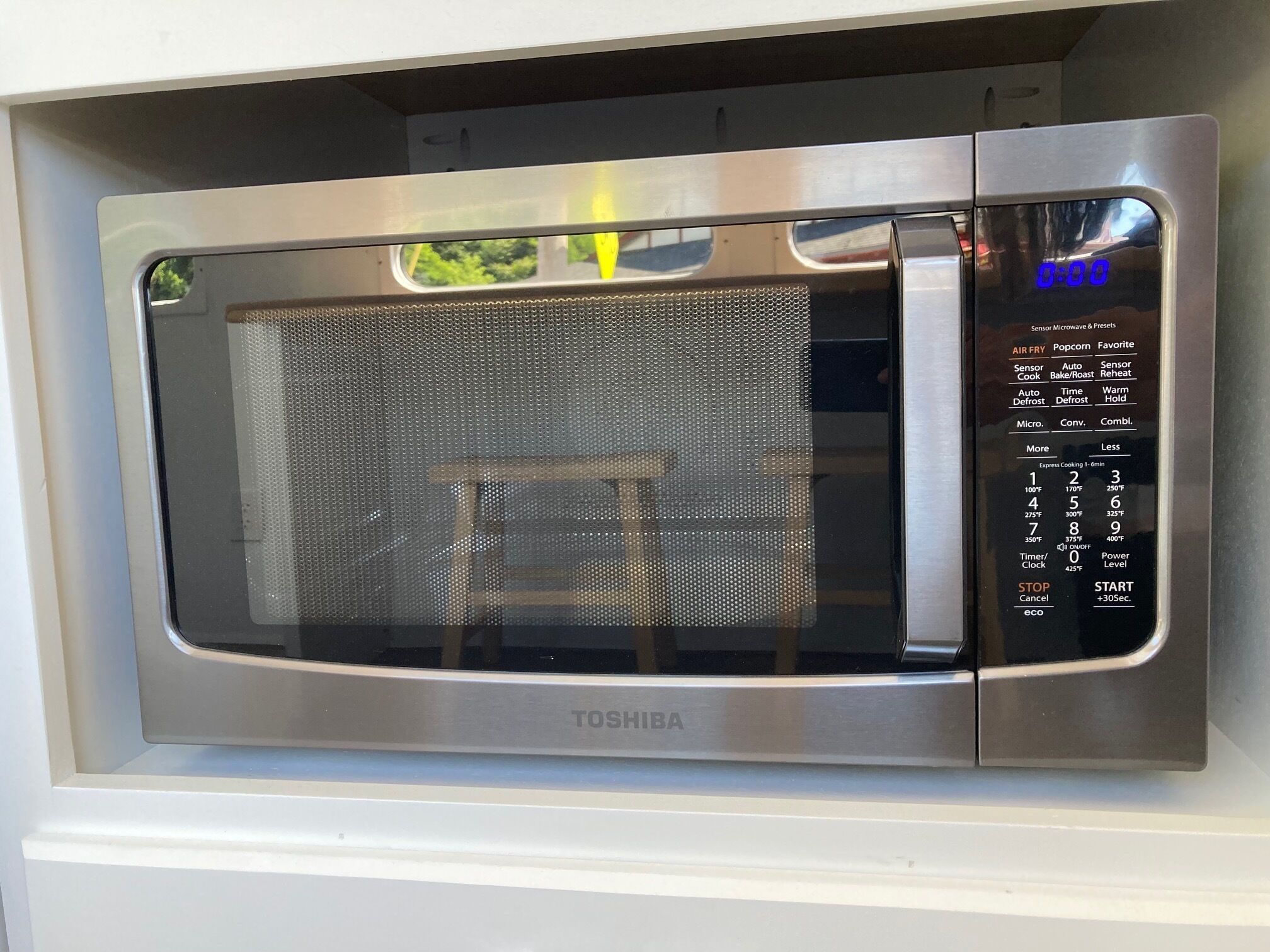 A Toshiba microwave oven with a digital display and multiple cooking settings.