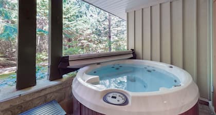 Renovated ground-floor condo with private hot tub, shared pool, walk to lifts