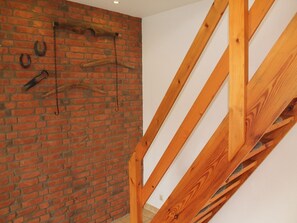 Ein Zimmer mit freiliegenden Holzbalken und einer Ziegelwand.