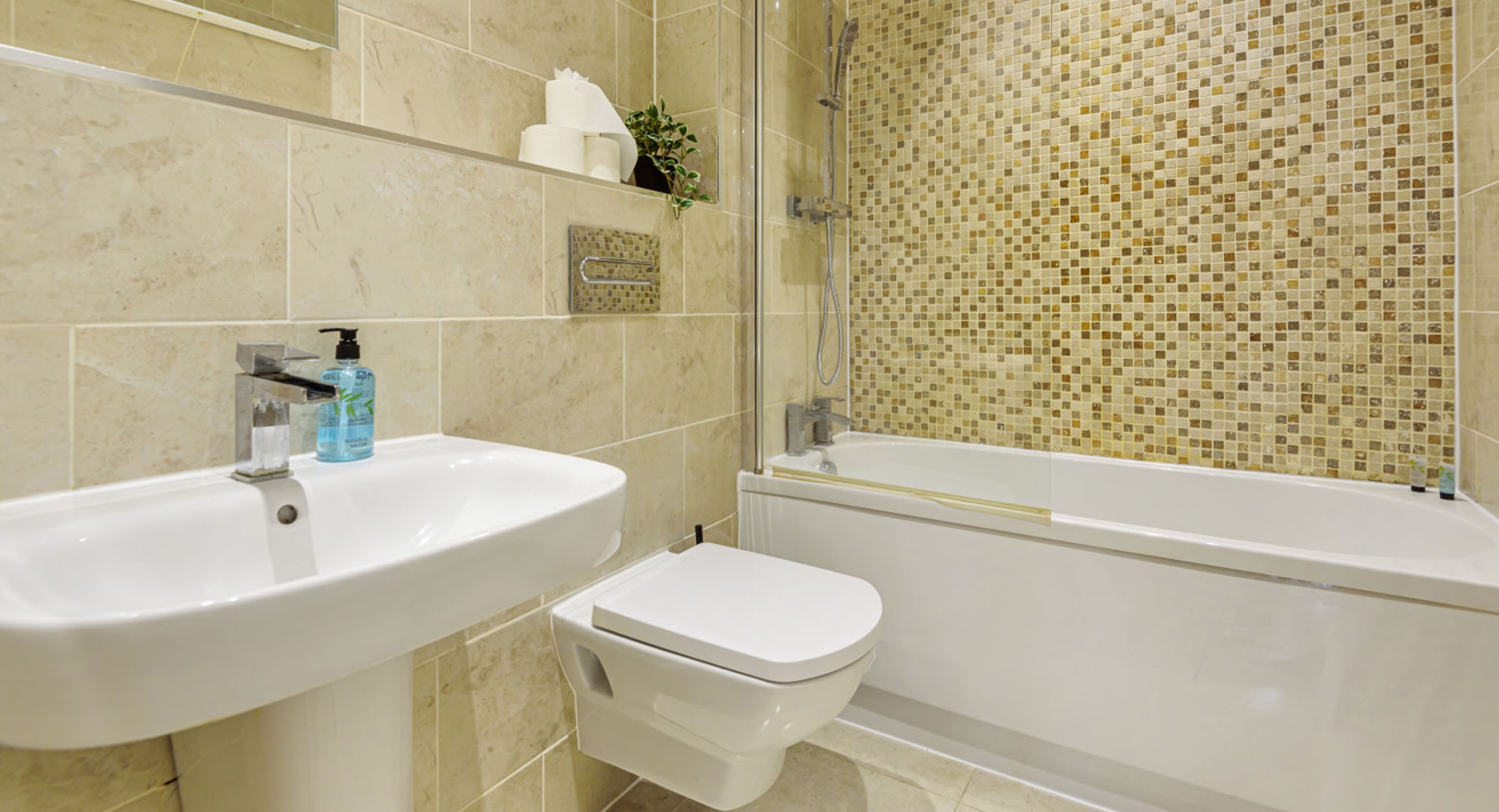 A bathroom with a sink, toilet, and bathtub.
