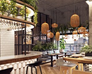 A modern bar area with wooden furniture, hanging wicker lamps, and potted plants. - John & Will Silo-Hotel by Guldsmeden (Bremen)