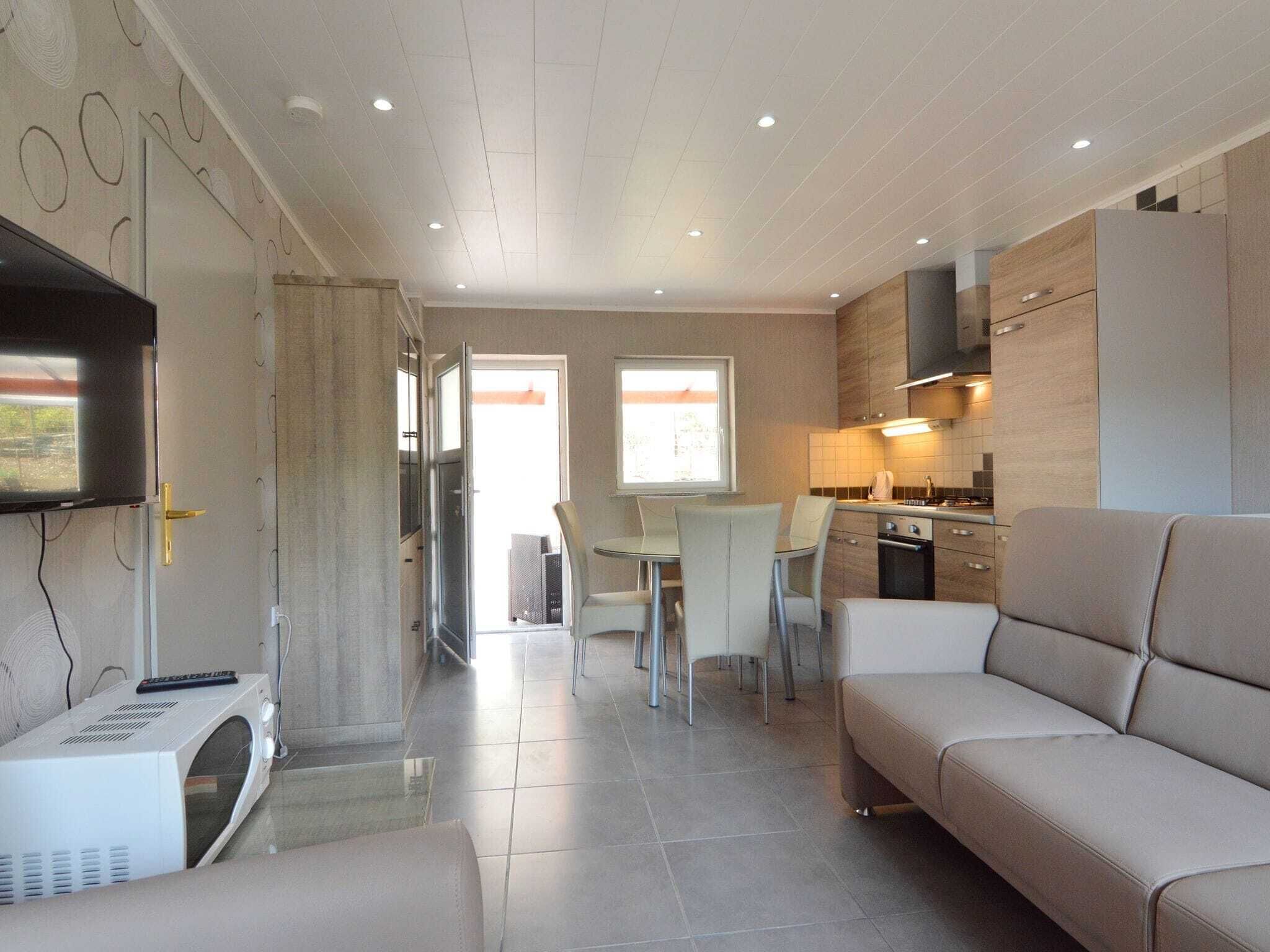 A compact living space with a kitchenette, a dining area, and a seating area.