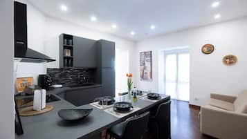 Suíte família, sacada, vista para a cidade | Cozinha privada | Máquina de café expresso, chaleira elétrica, produtos de limpeza