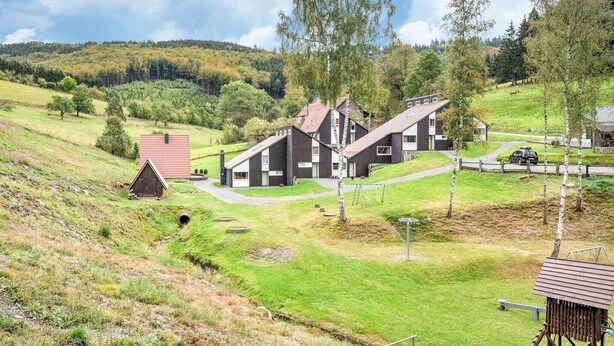 A rural setting with a modern house, a small barn, and a path leading to the house. - Ferienhaus mit herrlicher Aussicht (Bestwig-Untervalme)