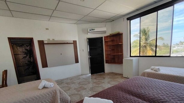 Family Triple Room, Balcony | Desk, laptop workspace, WiFi (free) - HOSTAL LOS CACTUS  (Puerto Villamil)