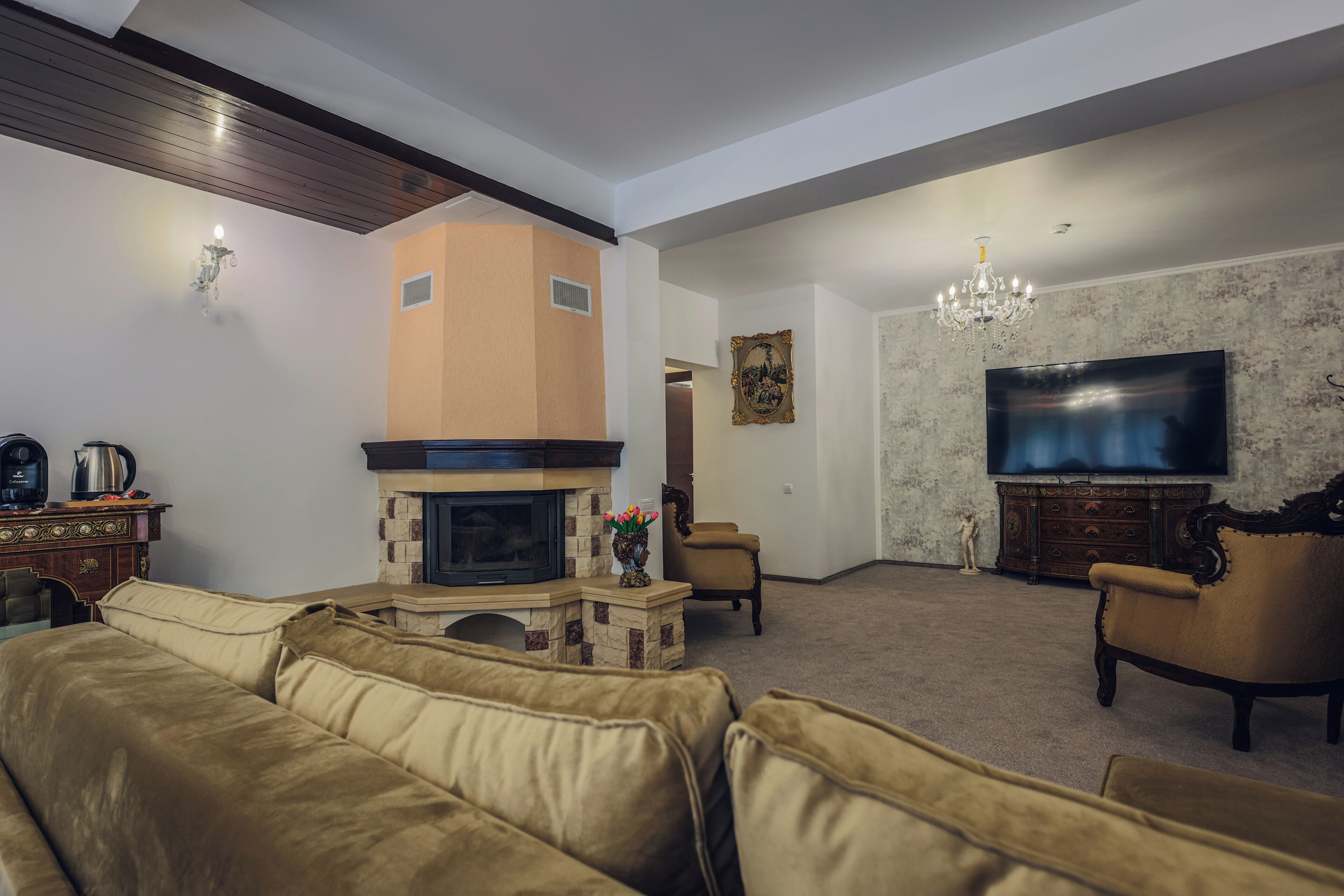 A living room with a fireplace, a television, and a sofa.