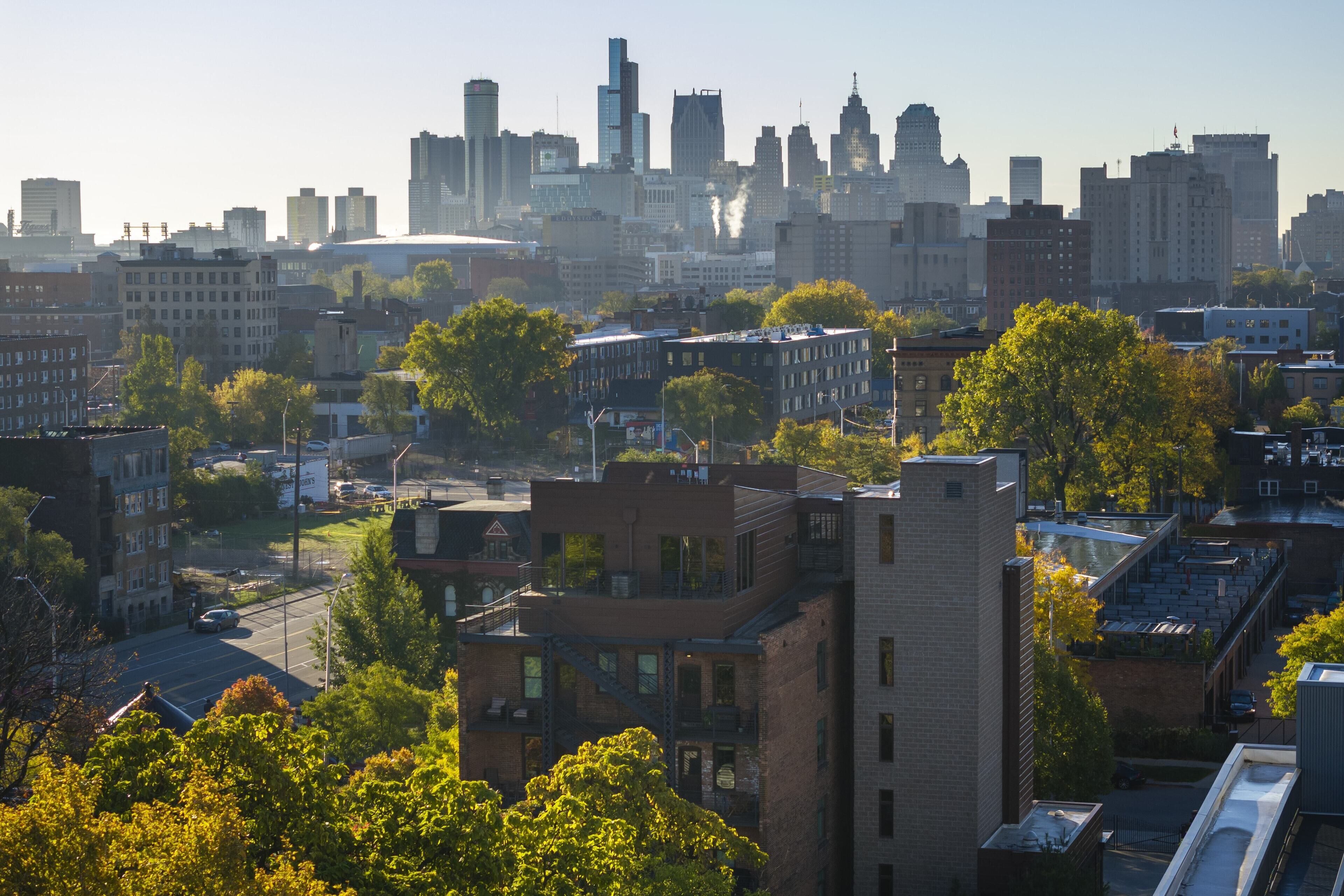 A cityscape with a mix of high-rise and mid-rise buildings, a river, and green spaces.