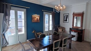 A dining area with a dark wooden table, clear chairs, a chandelier, and framed pictures on the walls. - Charming house downtown ARCEAUX 140M2. 4 bedrooms. Possible Prkg (Montpellier)
