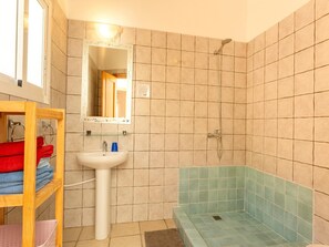 A bathroom with a sink, mirror, and shower. - Villa in Arenas with Sea Views and Private Pool (Arenas)