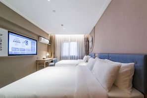 A hotel room with a large bed, a desk, and a TV screen displaying a menu. - Homeinn · neo (Zhengzhou Hanghai Road Chengdong Nanlu Subway Station) (Zhengzhou)