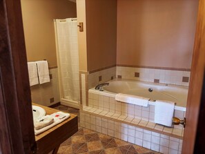 A bathroom with a bathtub, shower, and sink. - Quad Deluxe Cabin -Bungalow w/ Two Kitchens & 4 Bedrooms! (Golconda)