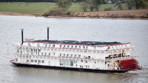 A large white paddle steamer with multiple decks and a prominent red paddle wheel, floating on a calm river. - Deluxe Suite - Bungalow overlooking the River! (Stone Church Precinct)