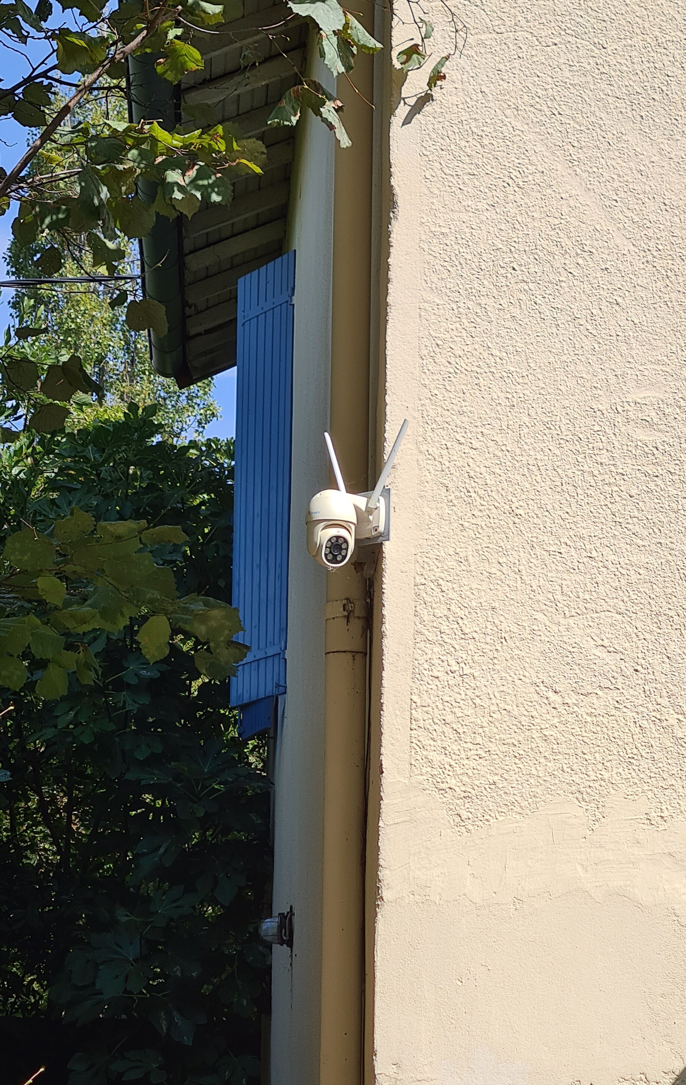 A security camera mounted on a building's exterior wall.