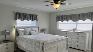 A bedroom with a bed, nightstands, a dresser, and a ceiling fan. - Cozy Home In Beverly Hills near Crystal River, Florida (Beverly Hills)