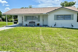 A single-story house with a front porch, a covered entryway, and a small front yard.