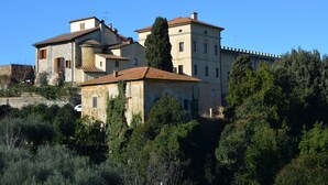 A historic building with multiple levels, stone walls, and a tiled roof. - Escape in Rosignano Hills (Rosignano Marittimo)
