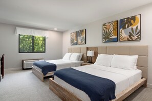 A hotel room with two beds, a large window, and artwork on the walls. - The Wave at Marblehead (Marblehead)
