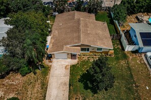 A single-story house with a tiled roof, a front garage, and a small front yard.