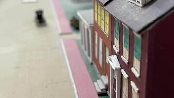 A model of a street with model houses, a model car, and a model train.
