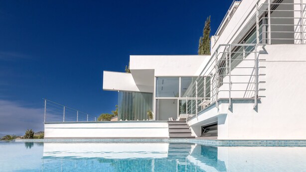 A modern building with a swimming pool, large windows, and a staircase leading to the upper levels. - Villa Petrer in Javea X bia (Javea)