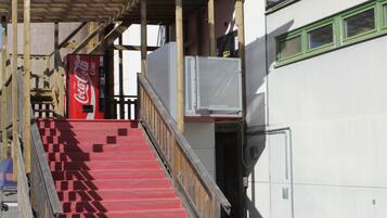 A staircase leading to a building with a solar panel structure on the left.