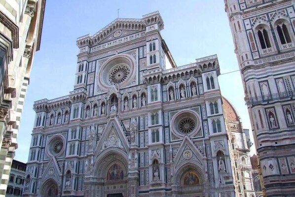 A historic building with intricate architectural details, including multiple arched windows and ornate facades.