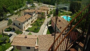 A residential area with multiple buildings, a swimming pool, and a clear view of the surrounding landscape.