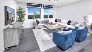 Una sala de estar moderna con un conjunto de sofá, una mesa de centro y un aparador.