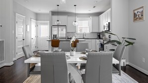 A modern kitchen with white cabinets, a central island, and pendant lighting. - Spacious Duplex, Near VCU, 5 Free Parking, Fenced (Richmond)