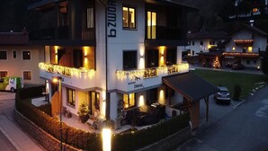 A multi-story hotel with balconies, a Christmas tree, and outdoor seating.