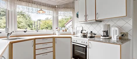 Fridge, stovetop, dishwasher, coffee/tea maker