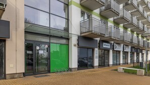 A modern building with multiple balconies, large windows, and a brick-paved ground. - Potulicka Coffee Studio (Szczecin)