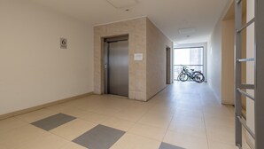 A hallway with a tiled floor, a door, and a bicycle in the background. - Potulicka Coffee Studio (Szczecin)