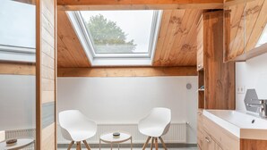 A modern kitchen with wooden cabinets, a white countertop, and a skylight. - holiday home in Goirle with sauna (Goirle)