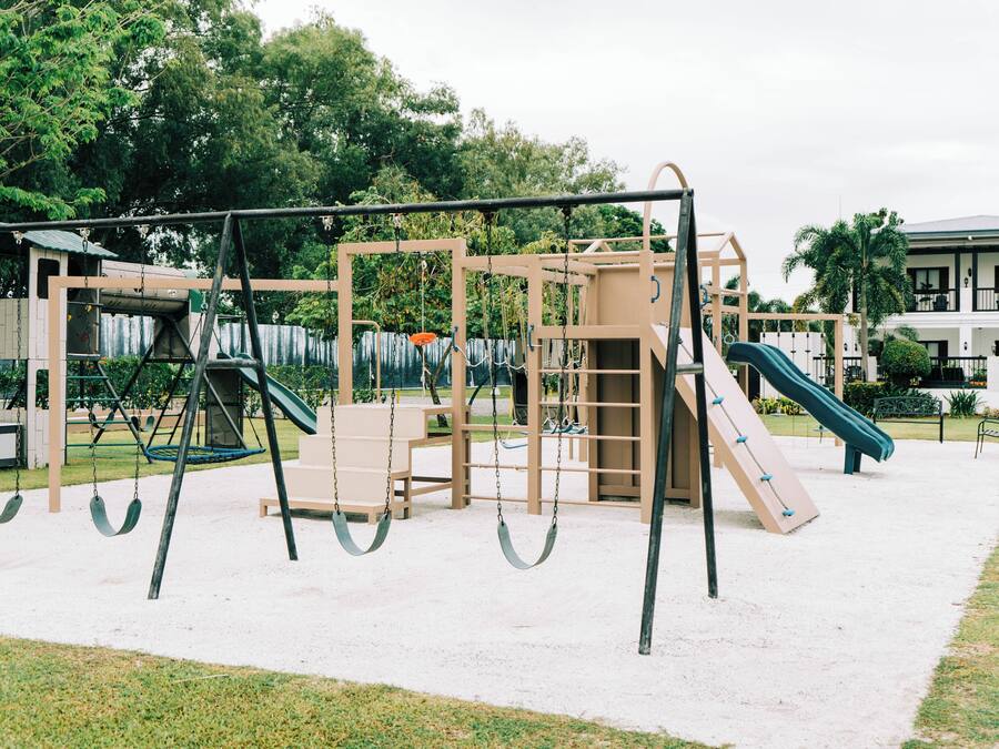 Un parque infantil con columpios, toboganes y estructuras para escalar.