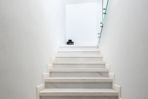 A staircase with white steps leading to a landing.