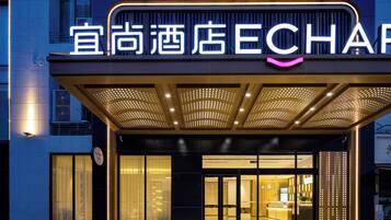 Experience the warm welcome of ECHA, where a striking illuminated sign and arched entrance invite you in.
